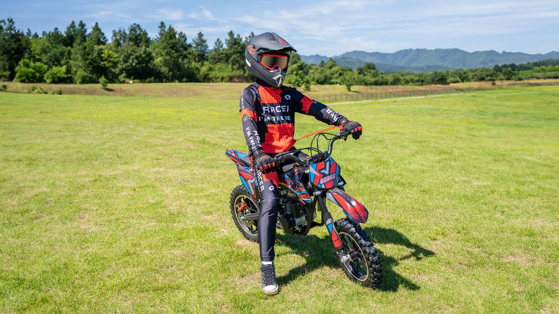 A kid is sitting on the Ogemaw 40 gas dirt bike.