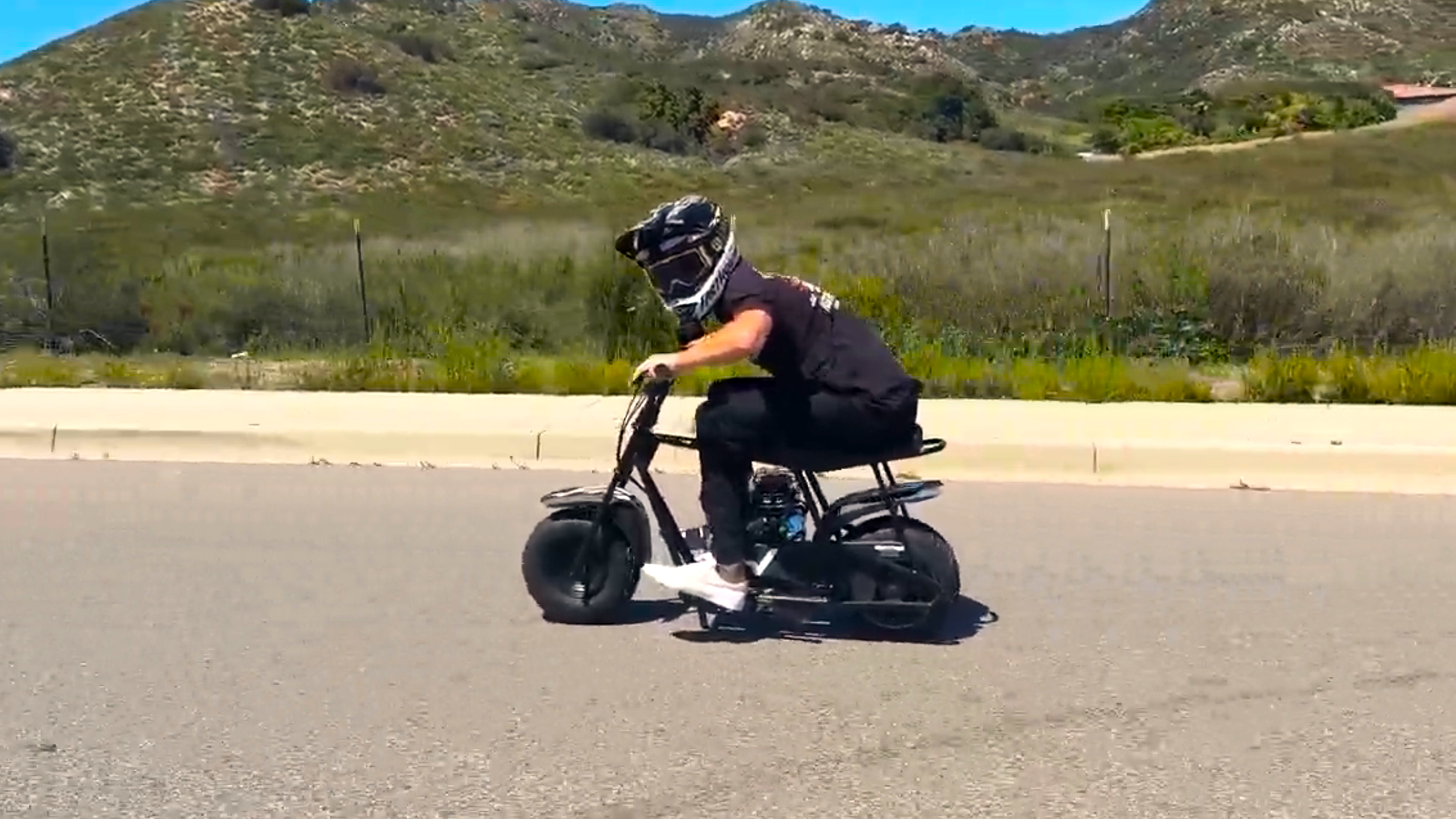 A man is riding GMB100 gas mini bike