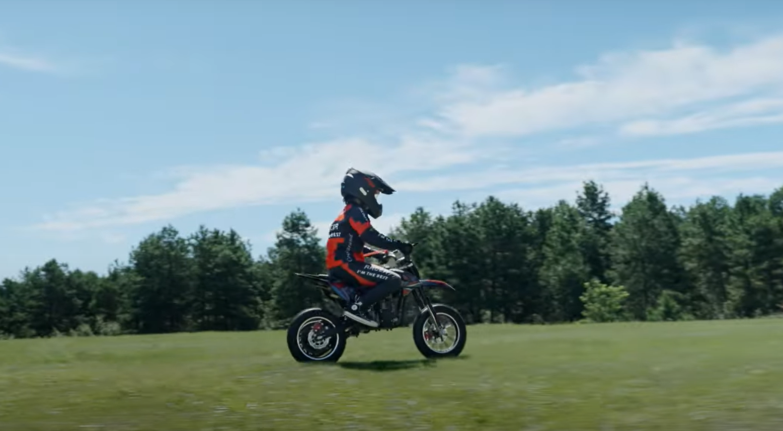 A kid is riding Ogemaw 40 gas mini dirt bike on the lawn
