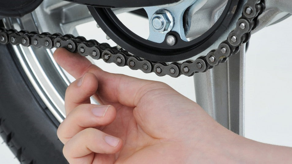 <img src= How do you tighten the chain.jpg alt= a person is testing the chain tension of the bike/>