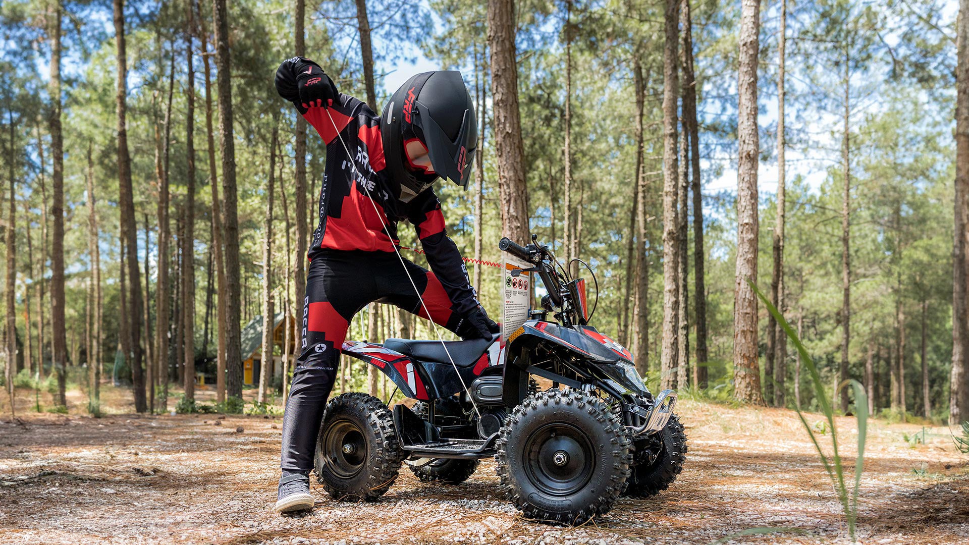 A kid is pulling start the FRP Sahara 40 mini quad.