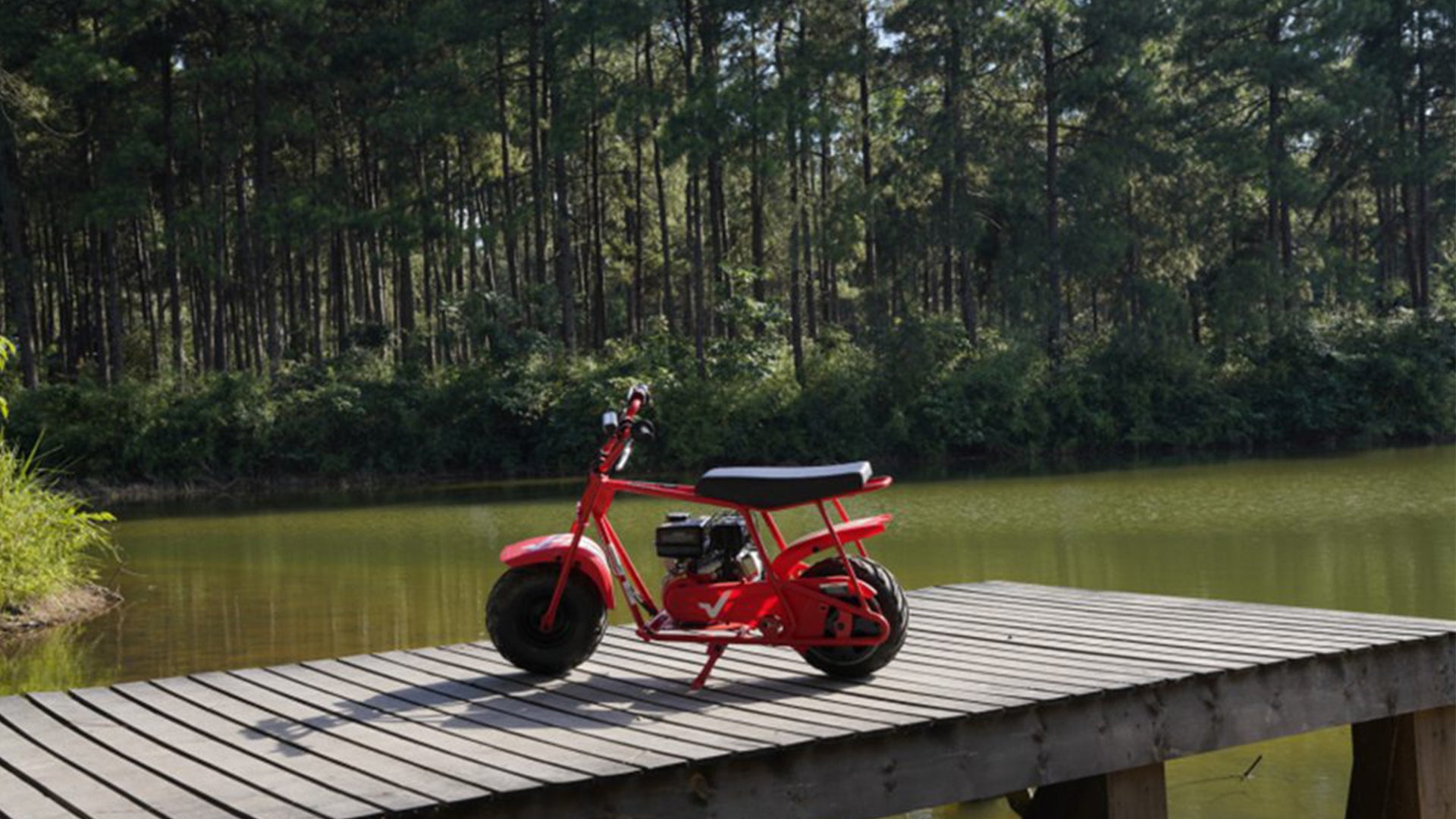 A GMB100 mini bike near a lake.