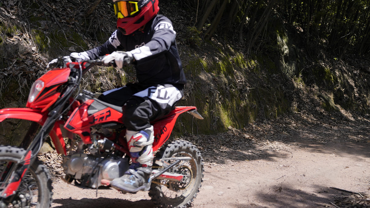 FRP FX140 140cc dirt bike ridden on a dirt trail