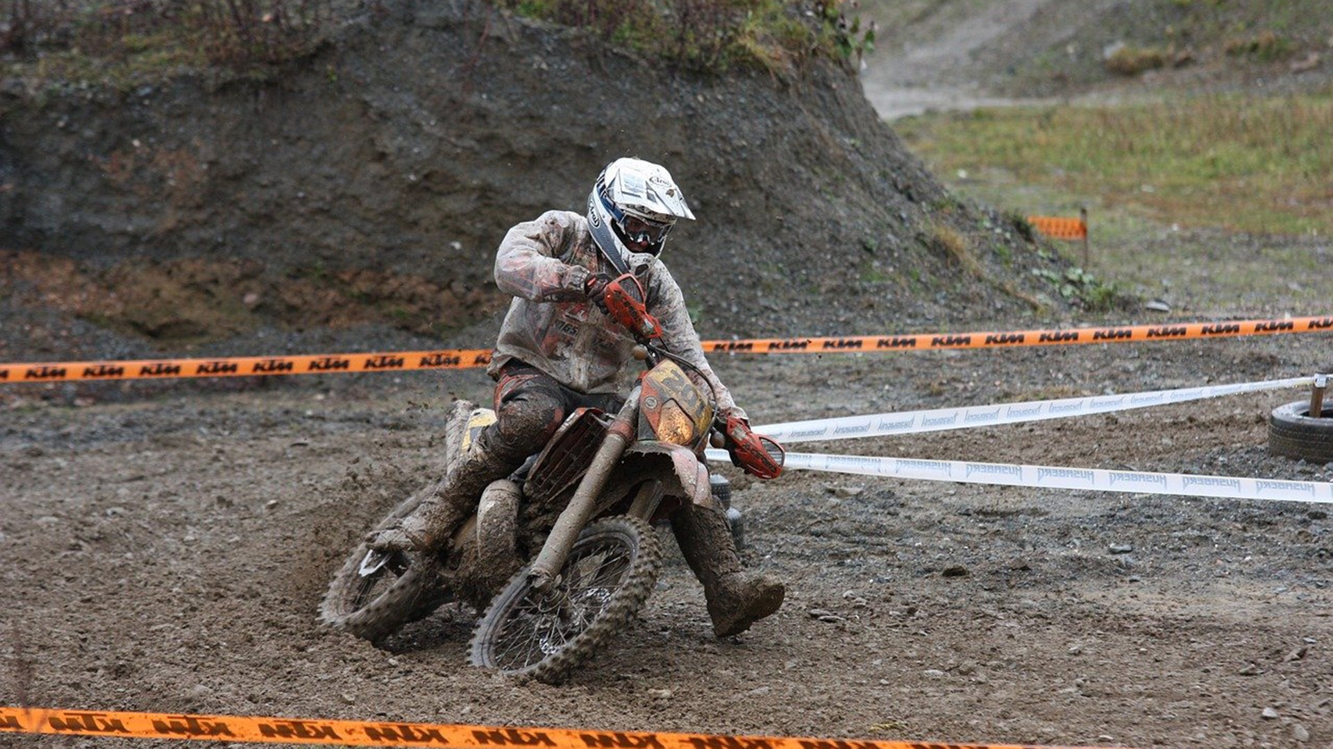 A man is riding a dirt bike on the trail.
