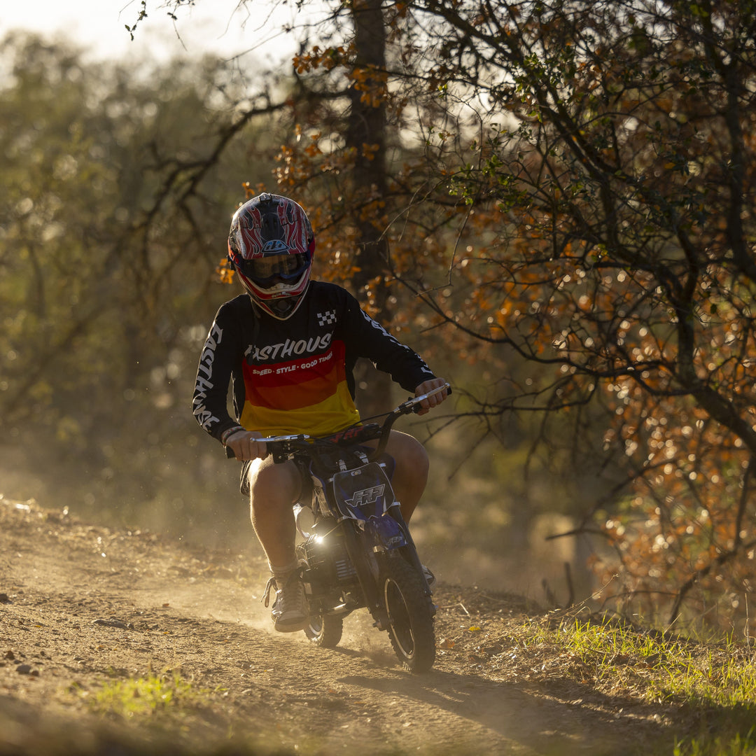 A boy is riding FRP kids dirt bike DB001.