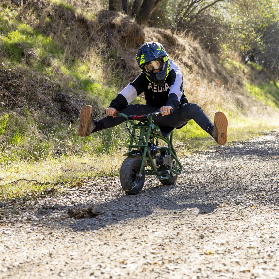 The little boy is riding a FRP kids mini dirt bike happily.
