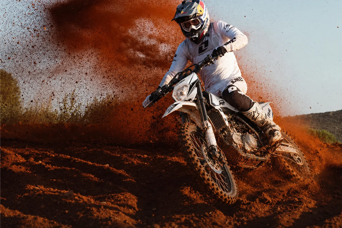 FRP Moto FX140 dirt bike rider roosting dirt on a motocross berm - all FRP Moto models collection banner