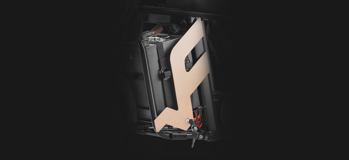 FRP M3 battery strapped inside the frame behind the F-shaped cover, with the key in the cover lock